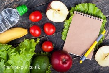 Photo of a note pad and pen next to some fruit and veg