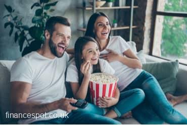 Photo of family on the sofa eating popcorn