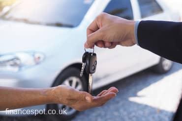 Photo of someone handing over the keys to a car they have sold